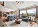 Cozy living room with mountain views, comfortable seating, large windows, and open floor plan at 3961 Mossy Rock Ln, Evergreen, CO 80439