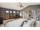 Main bedroom featuring vaulted ceilings, mountain views, and ensuite bathroom at 3961 Mossy Rock Ln, Evergreen, CO 80439