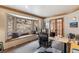 Bright home office with bay window seating, wood trim, and views of natural landscape at 3961 Mossy Rock Ln, Evergreen, CO 80439