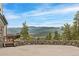 Scenic view from the home with a stone patio and stunning mountain vistas at 3961 Mossy Rock Ln, Evergreen, CO 80439