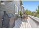 Outdoor balcony featuring a table, chairs, grill, and space for entertaining at 9921 W Edenburg Pl, Littleton, CO 80127