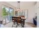 Cozy dining area with modern light fixture and sliding doors leading to the deck at 9921 W Edenburg Pl, Littleton, CO 80127