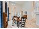 Elegant dining room with vaulted ceilings, hardwood floors, and decorative light fixtures at 9921 W Edenburg Pl, Littleton, CO 80127