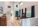 Elegant dining room with vaulted ceilings, hardwood floors, and bright natural light at 9921 W Edenburg Pl, Littleton, CO 80127