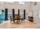 Elegant dining room with vaulted ceilings, hardwood floors, and bright natural light at 9921 W Edenburg Pl, Littleton, CO 80127