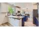 Modern kitchen with an island, stainless steel appliances, and bright natural light at 9921 W Edenburg Pl, Littleton, CO 80127