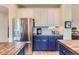 Close-up of the bright kitchen with stainless steel appliances and modern finishes at 9921 W Edenburg Pl, Littleton, CO 80127