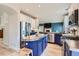 Bright kitchen featuring a large island with stone countertop and stainless steel appliances at 9921 W Edenburg Pl, Littleton, CO 80127