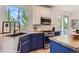 Modern kitchen featuring stainless steel appliances and a large window with natural light at 9921 W Edenburg Pl, Littleton, CO 80127