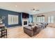 Spacious living room with a fireplace, large windows, and hardwood floors at 9921 W Edenburg Pl, Littleton, CO 80127