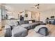 Bright living room with gray sectional couch, fireplace, and view to modern kitchen at 9921 W Edenburg Pl, Littleton, CO 80127