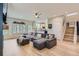 Open-concept living room with a large sectional sofa and view into the kitchen at 9921 W Edenburg Pl, Littleton, CO 80127