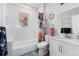 A bright bathroom with shower and vanity at 613 S Logan St, Denver, CO 80209