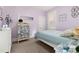 A peaceful bedroom with lavender walls and wooden floors at 613 S Logan St, Denver, CO 80209