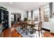 Light-filled dining room with a large wood table and a view into the living room at 613 S Logan St, Denver, CO 80209