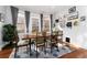 The dining room is filled with natural light, a wooden table, and hardwood floors at 613 S Logan St, Denver, CO 80209