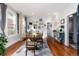 Bright dining room features hardwood floors, large windows, and a wooden table at 613 S Logan St, Denver, CO 80209