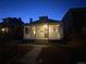 Inviting home exterior at dusk with a cozy front porch and warm lighting at 613 S Logan St, Denver, CO 80209