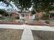 Charming home with a landscaped front yard, brick accents, and inviting entrance at 613 S Logan St, Denver, CO 80209
