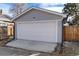 A well-maintained detached garage with a white door and gray siding at 613 S Logan St, Denver, CO 80209