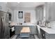 Modern kitchen with stainless steel appliances, grey cabinets, and butcher block island at 613 S Logan St, Denver, CO 80209