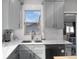 A modern kitchen with stainless steel appliances, and a white tile backsplash at 613 S Logan St, Denver, CO 80209