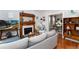 Bright living room featuring a fireplace, hardwood floors and an open doorway to the dining room at 613 S Logan St, Denver, CO 80209