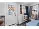 This sun room has a bright white door leading outside and built in shelving for storage at 613 S Logan St, Denver, CO 80209