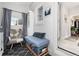 This sun room is decorated with a reading chair and soft, muted colors at 613 S Logan St, Denver, CO 80209