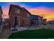 The house has a backyard with a patio, lawn, rock area, and a white picket fence at 5311 Blue Lunar Ln, Castle Rock, CO 80104