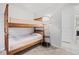 Bedroom with a wooden bunk bed, carpet, and a stylish floor lamp with shelves at 5311 Blue Lunar Ln, Castle Rock, CO 80104