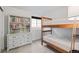Bright bedroom with a bunkbed, dresser with bookcase, and window with natural light at 5311 Blue Lunar Ln, Castle Rock, CO 80104