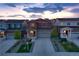 Beautiful two-story home with stone accents, a two-car garage, and a landscaped front yard at twilight at 5311 Blue Lunar Ln, Castle Rock, CO 80104