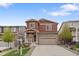 Charming two-story home with a stone and siding facade, a well-manicured lawn, and a two-car attached garage at 5311 Blue Lunar Ln, Castle Rock, CO 80104