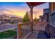 Inviting front porch view showcasing neighborhood homes against a colorful sunset sky at 5311 Blue Lunar Ln, Castle Rock, CO 80104