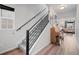 Hallway with wood floors, a carpeted staircase, and an adjacent living area at 5311 Blue Lunar Ln, Castle Rock, CO 80104