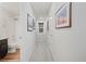 Hallway with light gray walls, a window, carpet floors, and access to the bathroom and other rooms at 5311 Blue Lunar Ln, Castle Rock, CO 80104