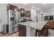Modern kitchen features stainless steel appliances, granite countertops, and an island with seating at 5311 Blue Lunar Ln, Castle Rock, CO 80104
