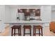 Kitchen island with granite countertop and seating for three, featuring stainless steel appliances at 5311 Blue Lunar Ln, Castle Rock, CO 80104