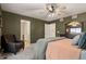 This main bedroom includes a ceiling fan, chair, and a large dresser with a mirror at 5311 Blue Lunar Ln, Castle Rock, CO 80104