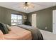 Comfortable main bedroom features a ceiling fan and large window with neighborhood views at 5311 Blue Lunar Ln, Castle Rock, CO 80104