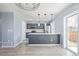 Modern kitchen featuring stainless steel appliances and an island, complemented by sleek countertops at 7008 Ralston Rd, Arvada, CO 80002