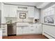 Modern white kitchen with stainless steel appliances and granite countertops at 3554 S Ivanhoe St, Denver, CO 80237