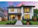 Stunning two-story modern home with a manicured lawn, sleek walkway, and stylish architectural details at 1518 S Columbine St, Denver, CO 80210