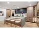 Modern kitchen island with wood cabinets, stone counters, and comfortable seating for a stylish and functional space at 1518 S Columbine St, Denver, CO 80210