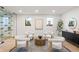 Stylish sitting room with four chairs arranged around a table atop a neutral rug, lit by recessed lighting at 1518 S Columbine St, Denver, CO 80210