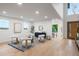 Bright living area with modern seating, hardwood floors, and a view into the dining area at 1518 S Columbine St, Denver, CO 80210