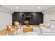 Modern living room features a large flatscreen TV, stylish wood accents, and comfortable seating arrangement at 1518 S Columbine St, Denver, CO 80210