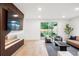 Comfortable living room with stylish fireplace, large screen TV, and access to outdoor space at 1518 S Columbine St, Denver, CO 80210