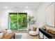Airy main bedroom with a view to the garden, modern lighting, and a comfortable lounge chair at 1518 S Columbine St, Denver, CO 80210